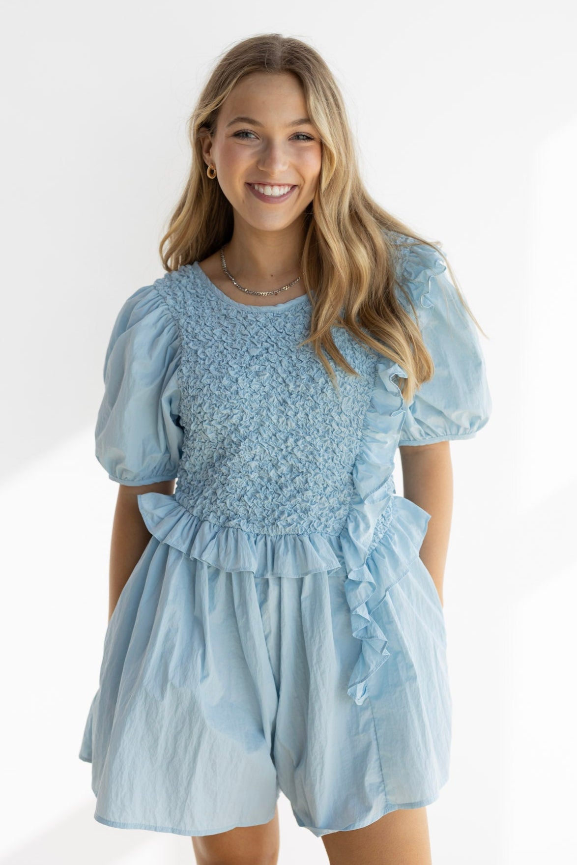 NOA RUFFLE SMOCKED ROMPER