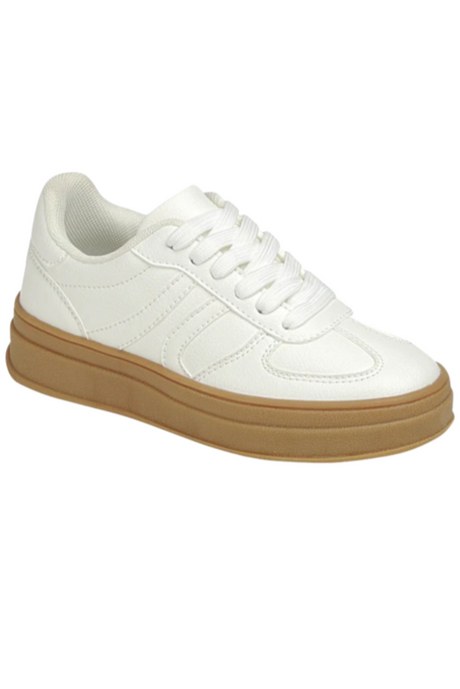 White sneaker with a brown sole on a white background