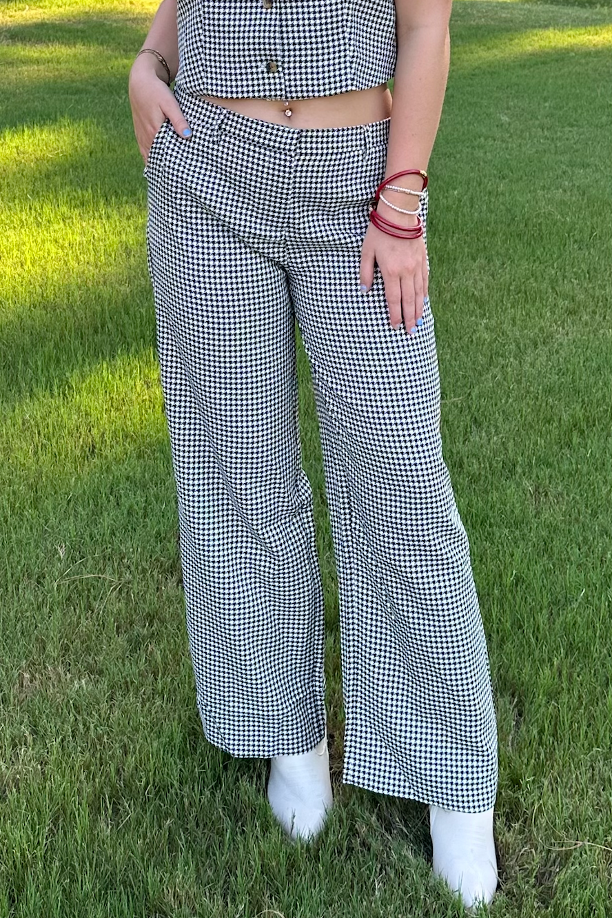 Person wearing a checkered outfit standing on grass