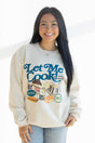 Woman wearing a cream sweatshirt with 'Let Me Cook!' graphic design on a white background