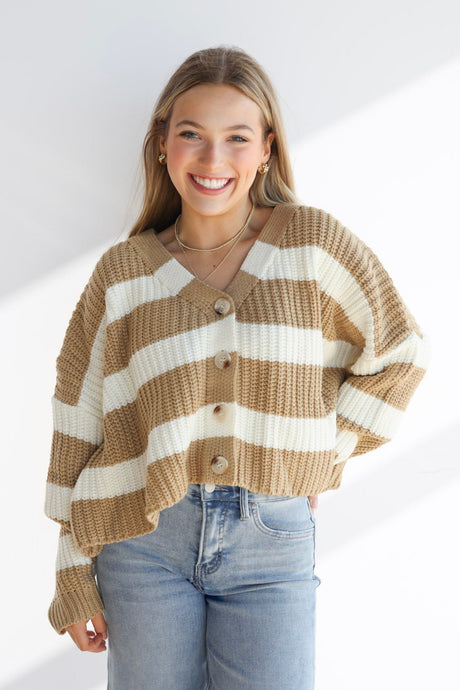 Woman wearing a striped sweater and jeans on a white background