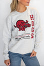 A female model wearing a gray sweatshirt with 'HOGS' and 'University of Arkansas' text on it.