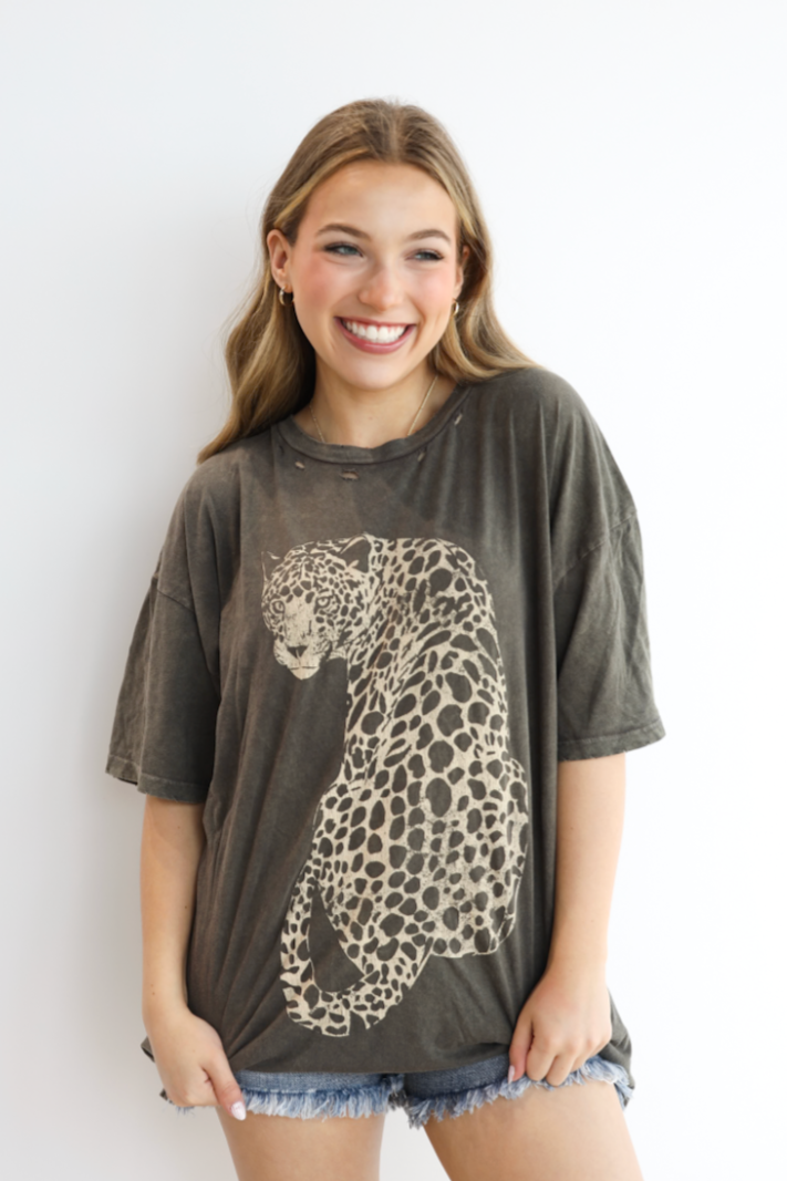 Woman wearing a t-shirt with a leopard print design against a white background