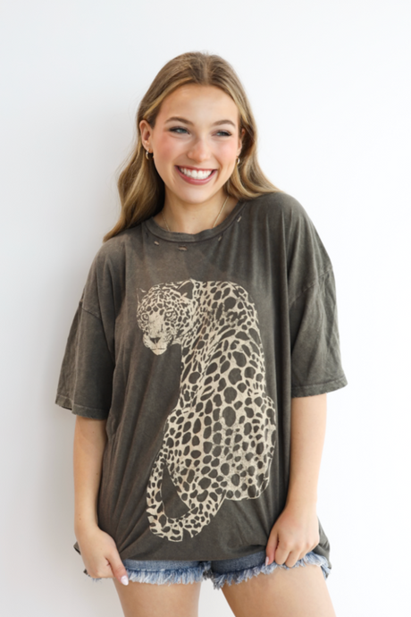 Woman wearing a t-shirt with a leopard print design against a white background