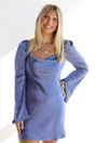 Woman wearing a blue dress with long sleeves on a white background