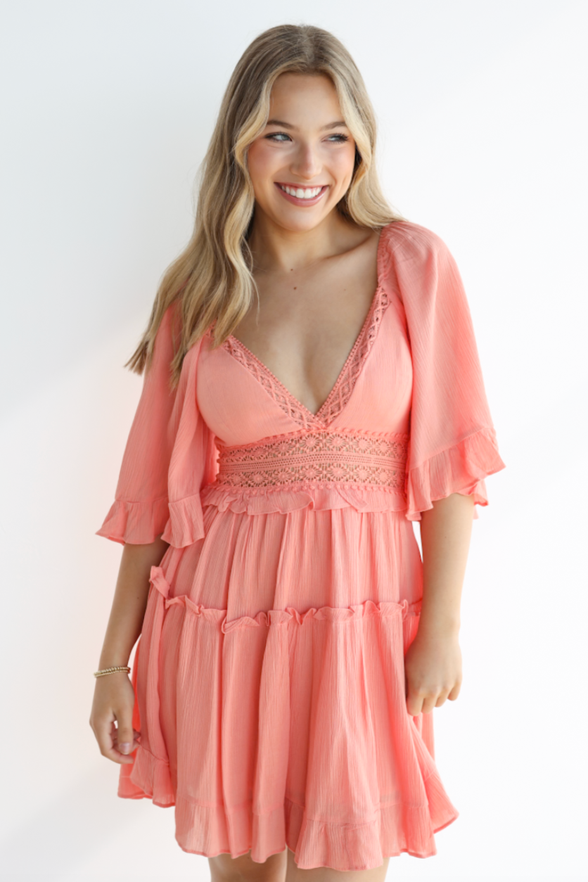 Woman wearing a pink dress with a white background